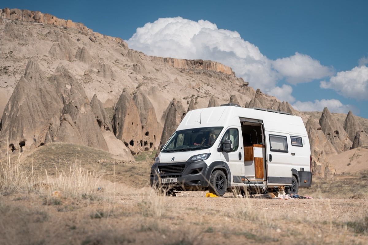 Campervan parked among fairy chimneys in Cappadocia, Turkey