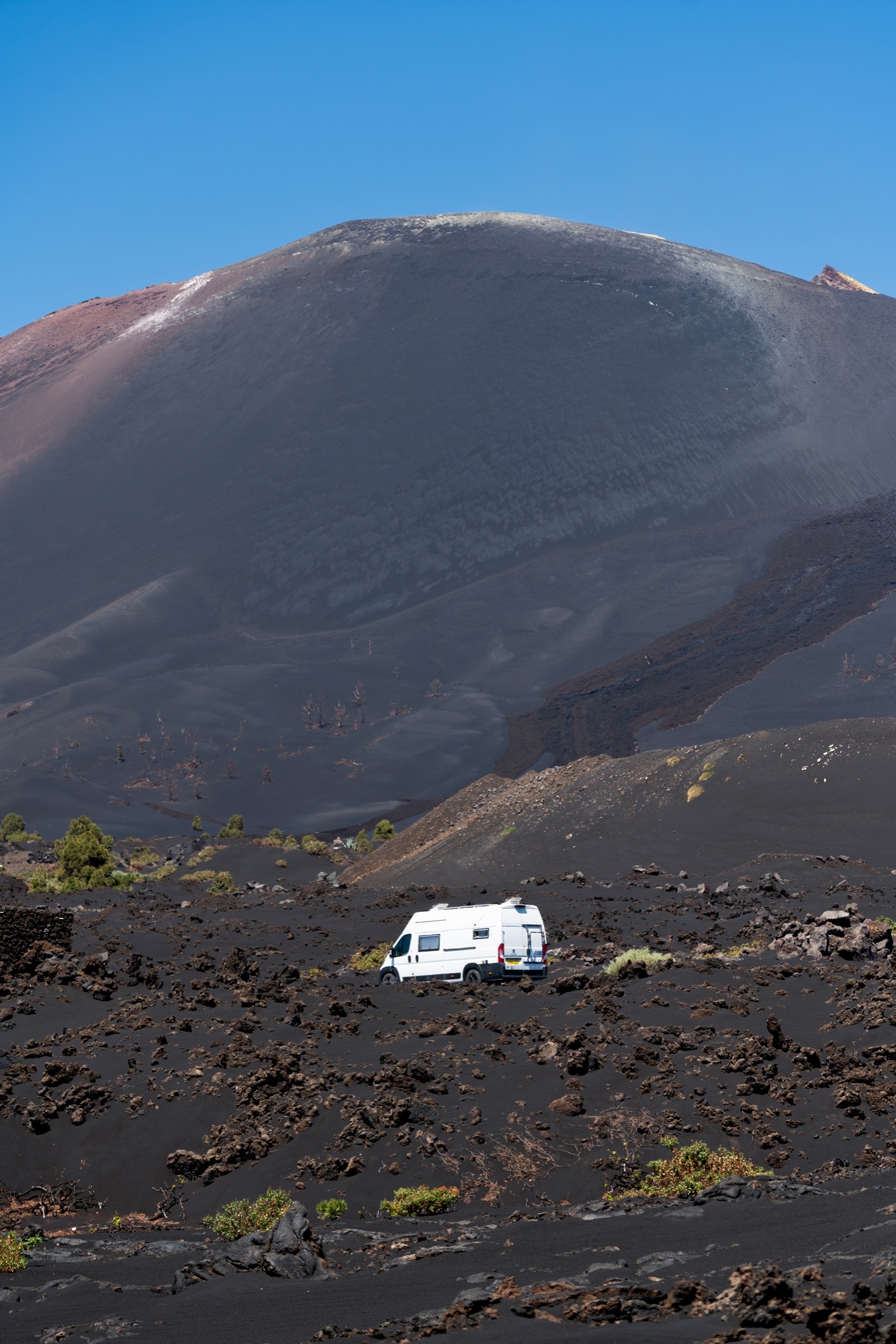 Campervan parked by a turquoise lake in Turkey